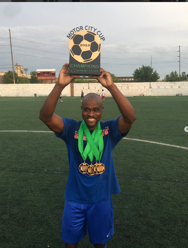 Moh celebrating with soccer championship trophy